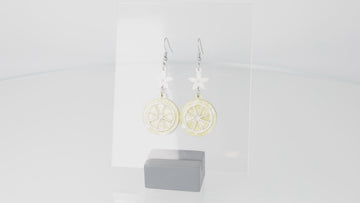 360 view of Lemon slice charms suspended fromn white flower charms on stainless steel earwires