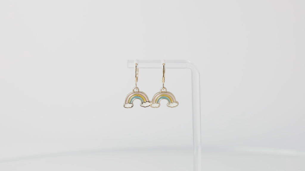 Gold plated stainless steel huggie hoop earrings with base metal rainbow charms featuring a cloud each side of the rainbow