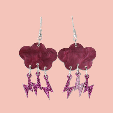 Deep purple marble clouds attached to purple glitter lightning bolt charms on stainless steel earwires