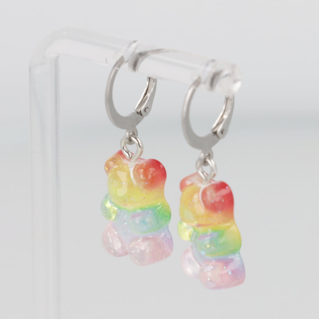 Sparkly rainbow gummy bear charms on stainless steel huggie hoops