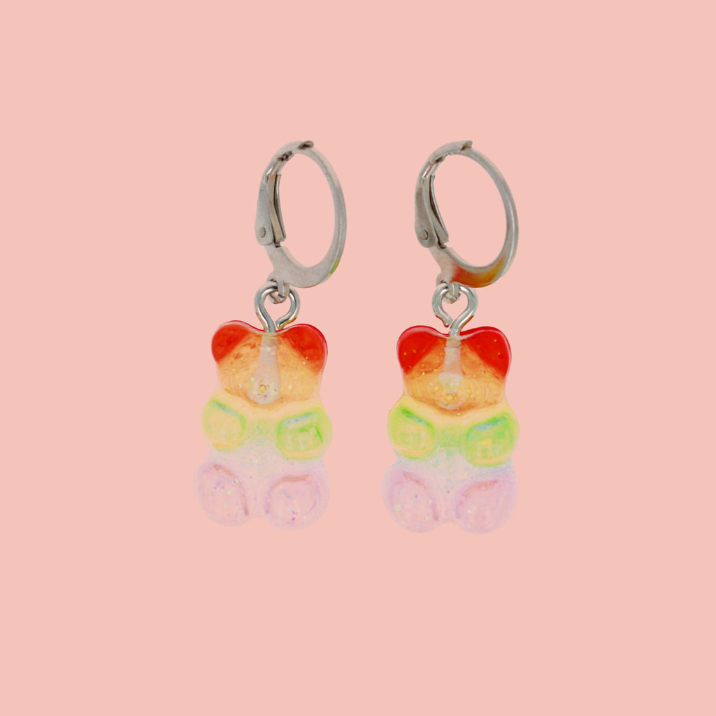 Sparkly rainbow gummy bear charms on stainless steel huggie hoops