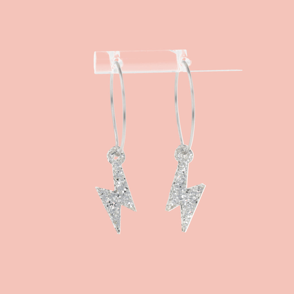 Mini Silver Glitter Lightning Bolt charms on stainless steel hoops