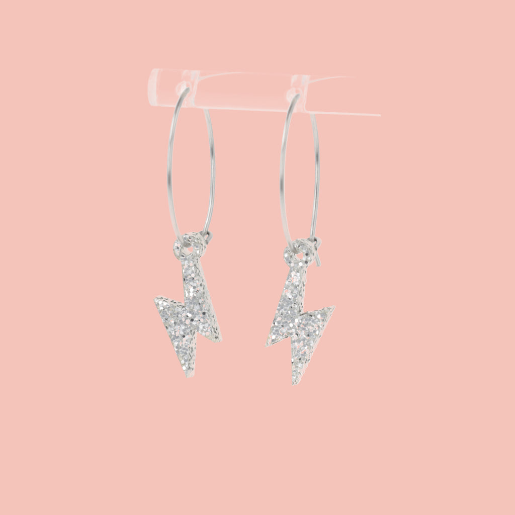 Mini Silver Glitter Lightning Bolt charms on stainless steel hoops